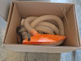 a cardboard box with a hose and a hose in it
