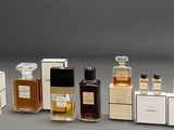 several different types of perfume bottles lined up on a gray surface