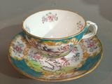 a tea cup and saucer sitting on a table