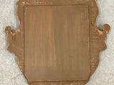 an image of a gold mirror hanging on a wall