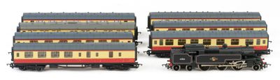 three model trains sitting next to each other on a white surface