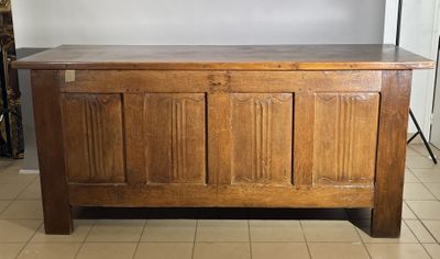 a wooden chest with a wooden top on a tiled floor