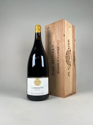 a bottle of wine sitting next to a wooden box