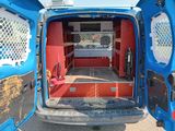 a blue van with a red interior parked in a parking lot