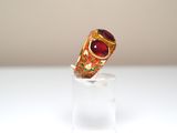 a ring that is sitting on top of a clear glass