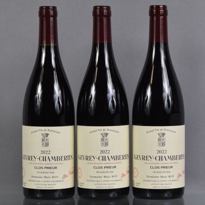 three bottles of wine are lined up on a table