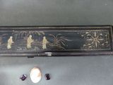 a black box with a painting on it next to a shell