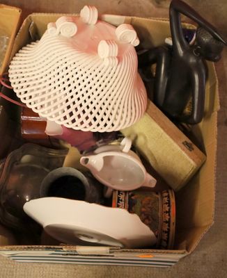 a cardboard box filled with assorted items on the floor