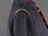 a blue jacket with red trims and buttons on a mannequin mannequin mannequin mannequin mannequin mannequin mannequin
