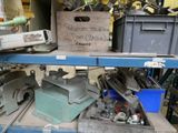 many different tools on a shelf in a garage