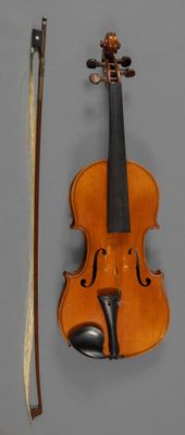 an old violin with a bow and a bow rest on a wall