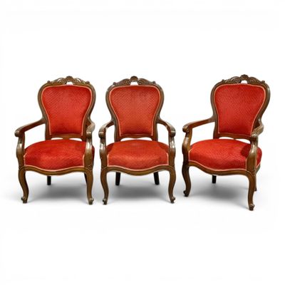 two red chairs sitting next to each other on a white surface