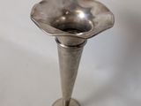 a silver vase that is sitting on a table