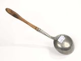 a close up of a ladle with a wooden handle on a white surface