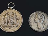 an image of a silver coin and a silver coin on a black background