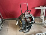 a machine that is sitting on the floor next to a red wall