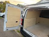 a white van with the door open in a parking lot