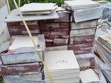 a pile of books sitting on a pallet in the yard