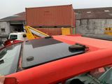 a red truck that is parked in front of a building