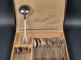 a box of silverware with a spoon and spoon rest in it