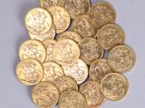 a pile of gold coins sitting on a white surface