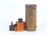two old tins and a canister on a white surface