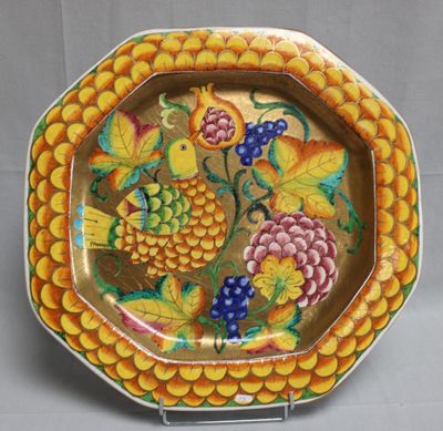 a decorative plate with a bunch of grapes on it