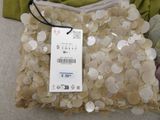 a bag of buttons on a bed with a price tag on it