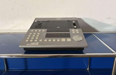 a small electronic device sitting on top of a blue table
