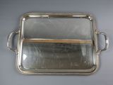 silver plated serving tray with handles and handles on a table