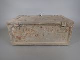 an old metal box sitting on top of a gray surface