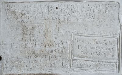 a plaque on the side of a building that has writing on it