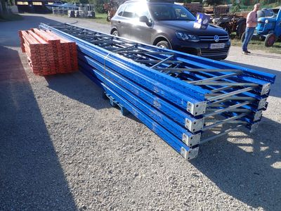 a pile of blue steel bars sitting on the side of the road