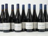 six bouteilles de vin rouge alignées sur une table