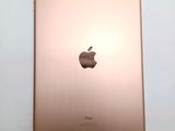 the back of an ipad with a gold apple logo on it