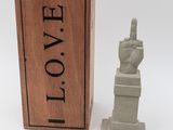 wooden box with a statue of a hand in front of it and a wooden box with a statue of a hand in front of it