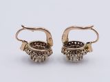 two pairs of gold and diamond earrings on a white background