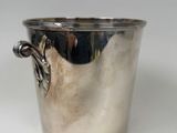 a silver cup that has a handle on it