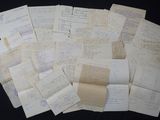 many papers are stacked on top of each other on a table