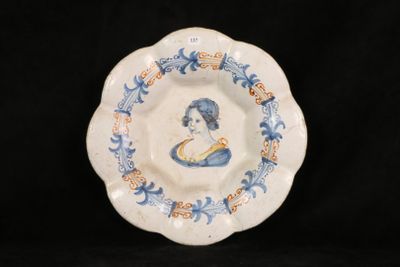 a blue and white plate with a picture of a woman on it