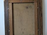 an old picture frame with a picture of a person in it