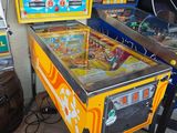 two pinball machines sitting next to each other on the floor