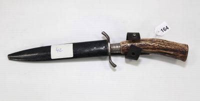 a knife with a wooden handle on a white surface