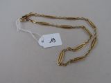 a close up of a gold chain with a tag on it