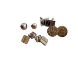 many different types of metal items that are on a white surface