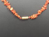 a necklace made of red coral and gold beads
