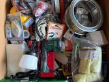 a cardboard box filled with assorted items on the floor