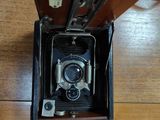 an old camera sitting in a case on a table