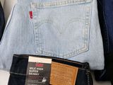 three pairs of levi ' s jeans are stacked on top of each other