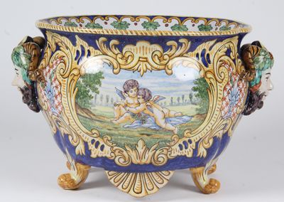 a blue and gold vase with a painting on it